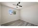 Bright bedroom featuring a ceiling fan, natural light, and modern flooring at 1427 W 6Th Dr, Mesa, AZ 85202