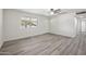 Bright living room showcasing gray wood flooring and a view of the front yard at 1427 W 6Th Dr, Mesa, AZ 85202