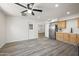 Open-concept living space with wood flooring and stainless steel refrigerator at 1427 W 6Th Dr, Mesa, AZ 85202