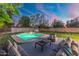 Stunning backyard pool with lounge area and well-manicured lawn at sunset at 1535 W Berridge Ln, Phoenix, AZ 85015