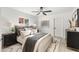 Bright bedroom features a ceiling fan, a soft rug, bedside tables and art at 1535 W Berridge Ln, Phoenix, AZ 85015