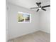 Bright bedroom featuring neutral walls, sleek fan, modern lighting and a large window at 1535 W Berridge Ln, Phoenix, AZ 85015