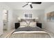 Bright bedroom features a ceiling fan, a soft rug, bedside tables and art at 1535 W Berridge Ln, Phoenix, AZ 85015