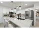 This kitchen features an island with marble countertops, seating, and stainless-steel appliances at 1535 W Berridge Ln, Phoenix, AZ 85015