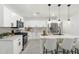 Bright kitchen features white cabinetry, stainless steel appliances, and an island with a marble countertop at 1535 W Berridge Ln, Phoenix, AZ 85015