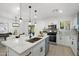 Modern kitchen features stainless steel appliances, white cabinets, and a stylish island with seating at 1535 W Berridge Ln, Phoenix, AZ 85015