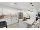 Modern kitchen features stainless steel appliances, white cabinets, and a stylish island with seating at 1535 W Berridge Ln, Phoenix, AZ 85015