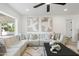 Bright living room features a comfortable sectional sofa, stylish decor, and a large window at 1535 W Berridge Ln, Phoenix, AZ 85015