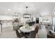 Open concept living with modern lighting, dining area, and kitchen featuring an island with seating at 1535 W Berridge Ln, Phoenix, AZ 85015