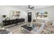 Bright living room features a comfortable sectional sofa, stylish decor, and a large window at 1535 W Berridge Ln, Phoenix, AZ 85015