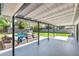 Inviting covered patio features a comfortable lounge area, swimming pool, and a lush green yard at 1535 W Berridge Ln, Phoenix, AZ 85015
