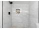 Bright shower with marble tiling, shower niche, and black hardware at 1535 W Berridge Ln, Phoenix, AZ 85015
