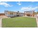 Spacious backyard featuring a covered patio, pergola, turf lawn, and outdoor seating at 1561 N Sterling St, Mesa, AZ 85207