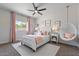 Stylish bedroom with pink accents, comfortable bed, and hanging chair at 1561 N Sterling St, Mesa, AZ 85207