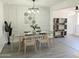 Bright dining room with modern chandelier, decorative wall art, and seating for six at 1561 N Sterling St, Mesa, AZ 85207