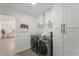 Modern laundry room equipped with machines, bright cabinets, and ample storage at 1561 N Sterling St, Mesa, AZ 85207
