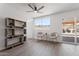 Bright living room with modern ceiling fan, sleek shelving, and a view to the patio at 1561 N Sterling St, Mesa, AZ 85207