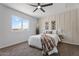 Serene main bedroom featuring a plush bed, modern decor, and a large window at 1561 N Sterling St, Mesa, AZ 85207