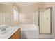 Bathroom featuring a tub, shower, vanity, and a tiled floor at 16209 W Acapulco Cir, Surprise, AZ 85379