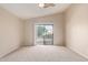 Bedroom featuring neutral walls, carpeted floors, and sliding glass doors to the backyard at 16209 W Acapulco Cir, Surprise, AZ 85379