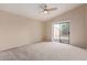 Spacious bedroom with a ceiling fan and a sliding glass door to the backyard at 16209 W Acapulco Cir, Surprise, AZ 85379