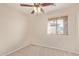 Bedroom with neutral walls, carpet, and window at 16209 W Acapulco Cir, Surprise, AZ 85379