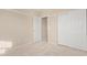 Cozy bedroom with neutral carpeting, closet, and door at 16209 W Acapulco Cir, Surprise, AZ 85379