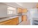 Functional kitchen with white appliances, tile backsplash, and window with a view at 16209 W Acapulco Cir, Surprise, AZ 85379