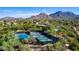 Aerial view of community pickleball courts with desert landscaping, homes and mountain views at 16420 N Thompson Peak Pkwy # 2101, Scottsdale, AZ 85260