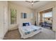 Comfortable bedroom with ceiling fan, carpet floors, and sliding glass doors to a balcony at 16420 N Thompson Peak Pkwy # 2101, Scottsdale, AZ 85260
