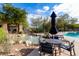 Community pool area features rock waterfall, built-in barbecue, seating and lounging areas with ample space at 16420 N Thompson Peak Pkwy # 2101, Scottsdale, AZ 85260