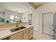 Well-lit kitchen featuring white countertops, double sink, and convenient access to outdoor patio at 16420 N Thompson Peak Pkwy # 2101, Scottsdale, AZ 85260