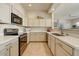 Modern kitchen with white cabinets, quartz countertops, and stainless steel appliances at 16420 N Thompson Peak Pkwy # 2101, Scottsdale, AZ 85260