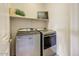 Functional laundry room equipped with modern washer and dryer units at 16420 N Thompson Peak Pkwy # 2101, Scottsdale, AZ 85260