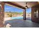 Pool area featuring a desert landscape and a covered patio, ideal for outdoor entertainment and relaxation at 17204 E Kensington Pl, Fountain Hills, AZ 85268