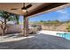 Covered patio showcases an outdoor area with a hot tub, pool, and lush landscaping, perfect for outdoor relaxation at 17204 E Kensington Pl, Fountain Hills, AZ 85268