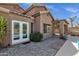Home exterior featuring a covered patio, white French doors and desert landscaping at 17204 E Kensington Pl, Fountain Hills, AZ 85268