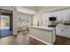 Kitchen with white cabinets, stainless appliances, island with sink and view of the pool at 17204 E Kensington Pl, Fountain Hills, AZ 85268