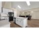 Modern kitchen with white cabinets, stainless steel appliances, and island flowing into the living room at 17204 E Kensington Pl, Fountain Hills, AZ 85268