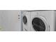 Laundry room with white stacked washer and dryer and a white door at 17204 E Kensington Pl, Fountain Hills, AZ 85268