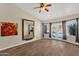A large living room with tile flooring, a ceiling fan, and a large mirror on the wall at 17204 E Kensington Pl, Fountain Hills, AZ 85268