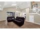 Open-concept living room with vaulted ceilings, wood flooring, and leather furniture adjacent to the kitchen at 17204 E Kensington Pl, Fountain Hills, AZ 85268