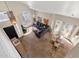 High-angle shot showcases a home's living room with a gray sofa and a dining area by the windows at 17204 E Kensington Pl, Fountain Hills, AZ 85268