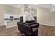 The living room features high ceilings, staircase and leather sofas, open to the kitchen with white cabinets at 17204 E Kensington Pl, Fountain Hills, AZ 85268