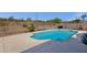 Backyard pool surrounded by desert landscape, enclosed by a block wall and wrought iron fence at 17204 E Kensington Pl, Fountain Hills, AZ 85268