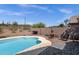 Backyard view of a sparkling swimming pool with desert landscape and privacy fencing at 17204 E Kensington Pl, Fountain Hills, AZ 85268