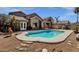 Backyard with a sparkling pool, landscaping, and a charming covered patio, ideal for outdoor entertaining at 17204 E Kensington Pl, Fountain Hills, AZ 85268