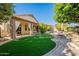 The backyard features an artificial lawn, a cozy fire pit and mature landscaping at 1807 W Canary Way, Chandler, AZ 85286