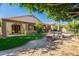 Beautiful backyard with patio cover, fire pit, artificial turf, and shade sails over a swimming pool at 1807 W Canary Way, Chandler, AZ 85286