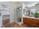 Bathroom showcasing a glass-enclosed shower and vanity, with access to a walk-in closet at 1807 W Canary Way, Chandler, AZ 85286